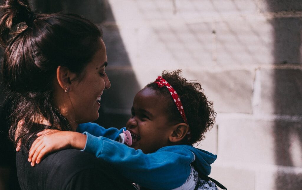 pexels-photo-1170899 Woman Holding Baby Wearing Blue Jacket